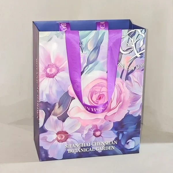 Floral Gift Bag with Purple Ribbon Handles