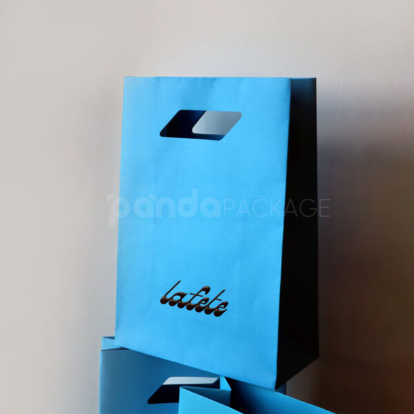 Bold Blue and White Retail Packaging Set with Die-Cut Handle Bag