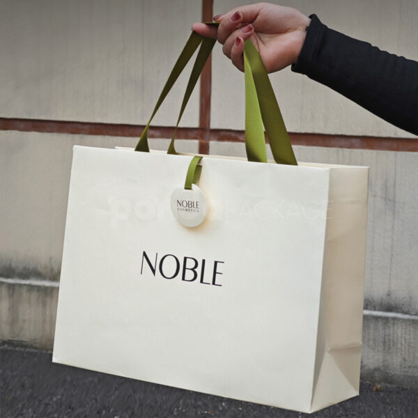 Elegant White Gift Bag with Green Ribbon Handles