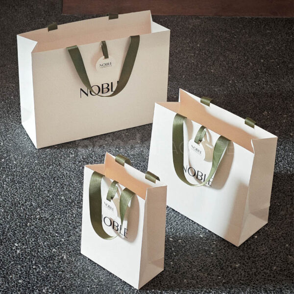 Elegant White Gift Bag with Green Ribbon Handles