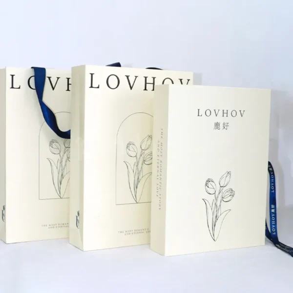 Elegant White Paper Gift Bag with Navy Ribbon Handles