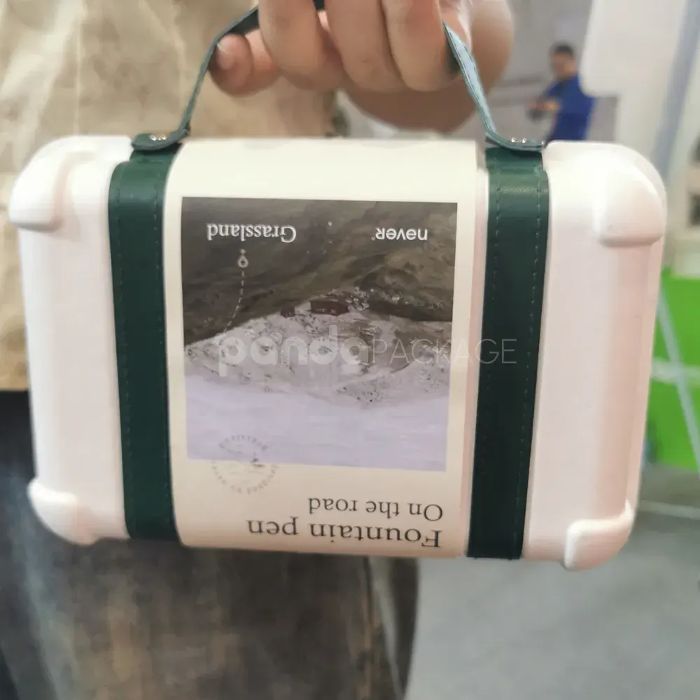 Elegant white gift box with luxurious green leather handle for gifting