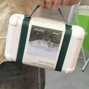 Elegant white gift box with luxurious green leather handle for gifting