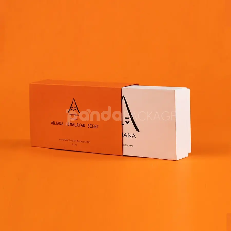 Ivory rigid lift-off box with orange sleeve packaging