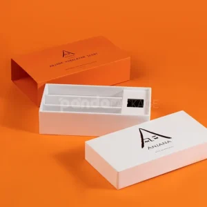 Ivory rigid lift-off box with orange sleeve packaging