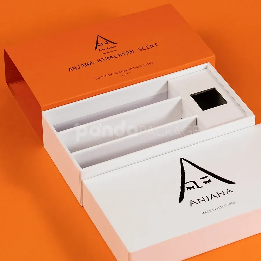 Ivory rigid lift-off box with orange sleeve packaging