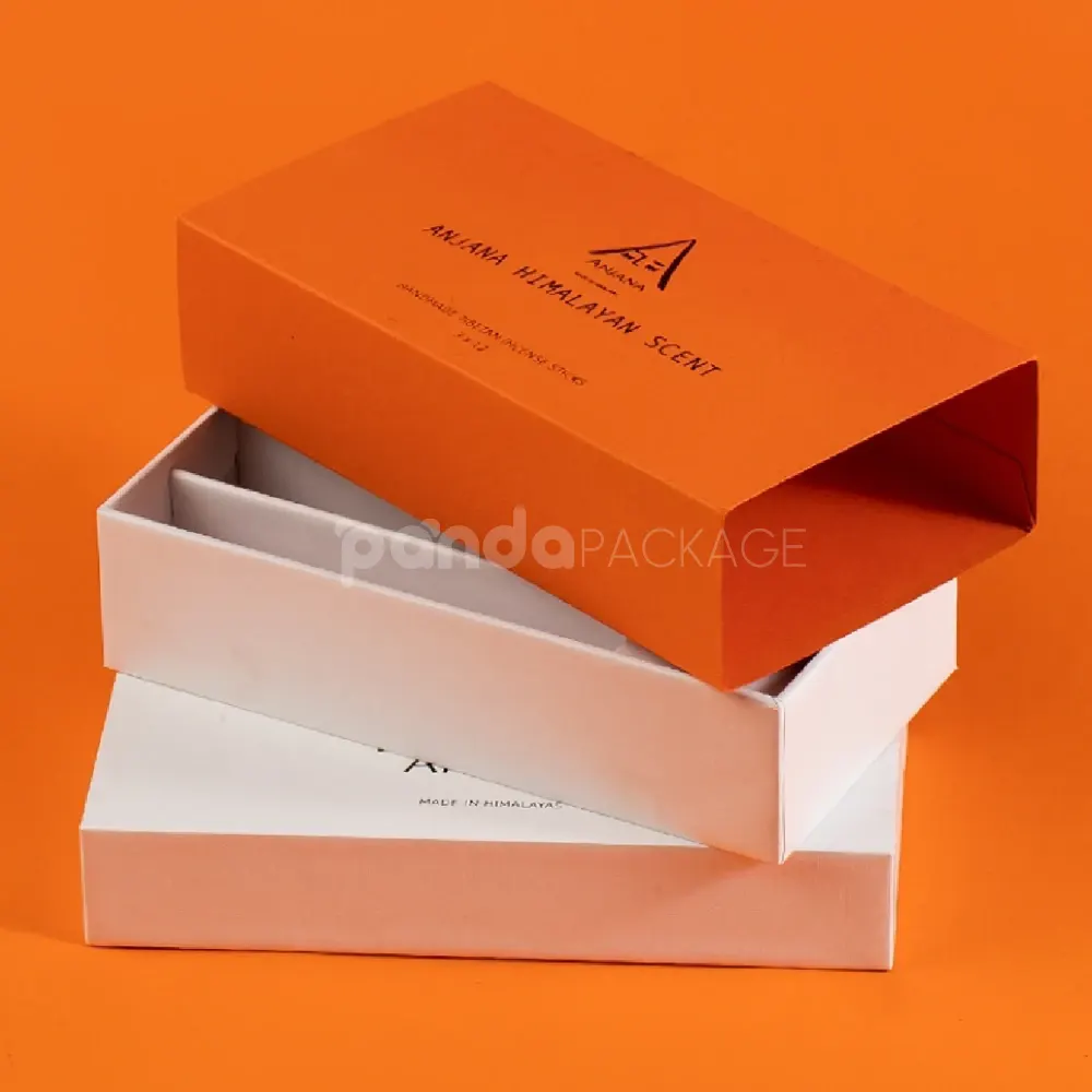 Ivory rigid lift-off box with orange sleeve packaging