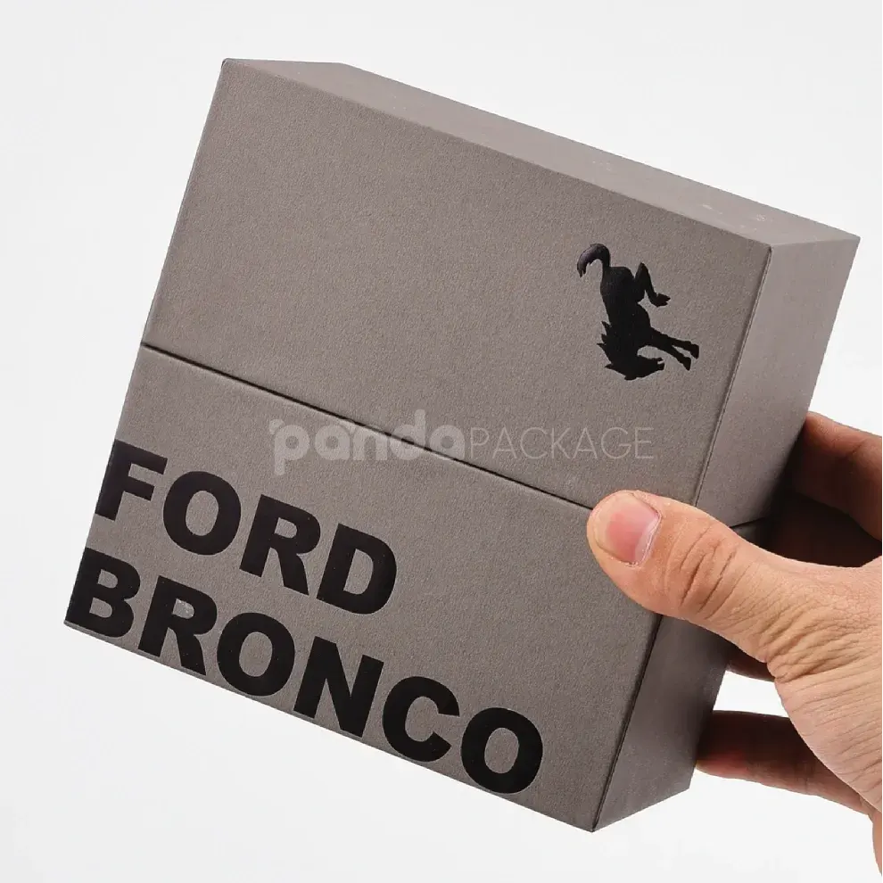 Luxury grey rigid box with lift-off lid and black foil stamped logo