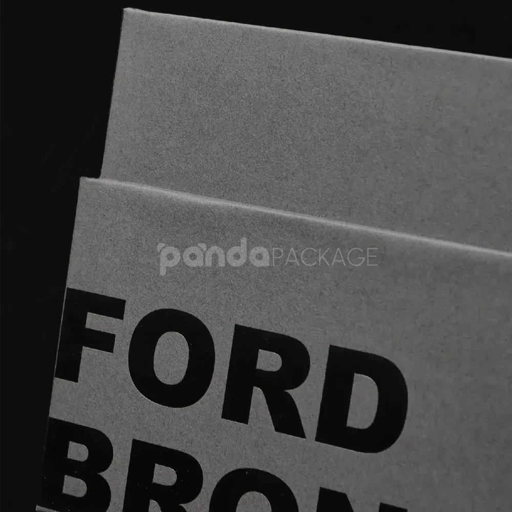 Luxury grey rigid box with lift-off lid and black foil stamped logo