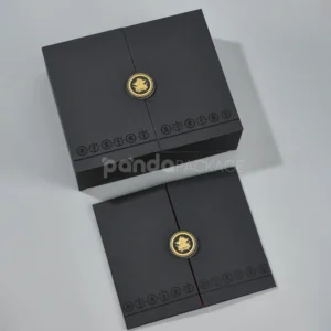 Black double door rigid gift box with gold foil medallion and red interior