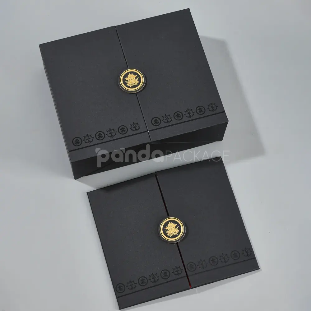 Black double door rigid gift box with gold foil medallion and red interior