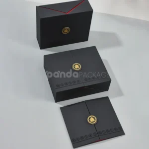Black double door rigid gift box with gold foil medallion and red interior