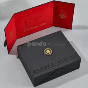 Black double door rigid gift box with gold foil medallion and red interior