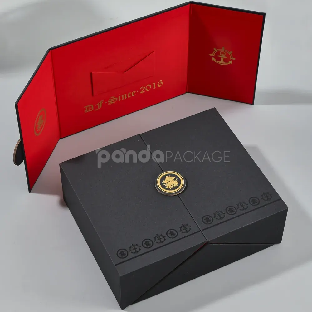 Black double door rigid gift box with gold foil medallion and red interior