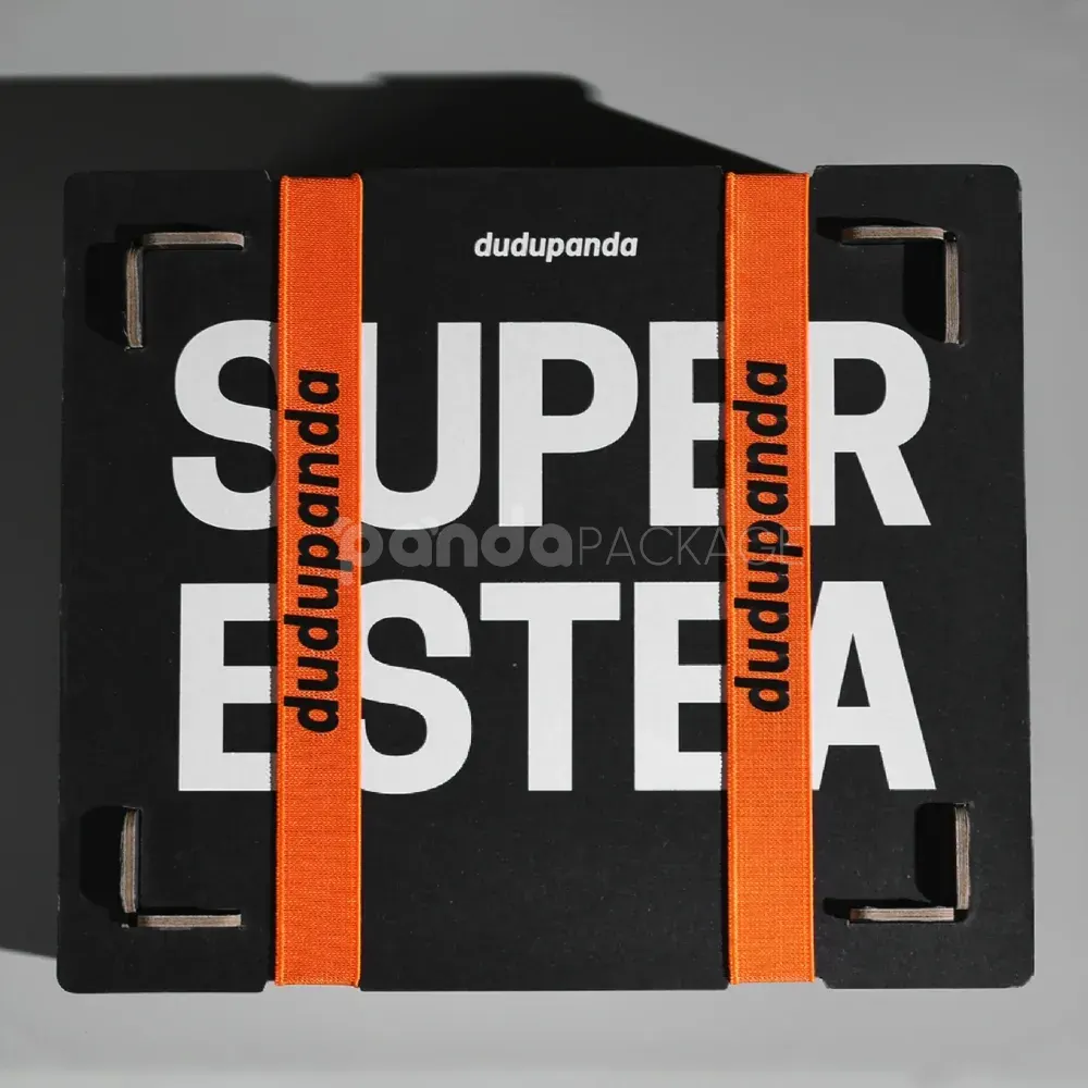 interlocking paperboard box with orange strap and slot-in panels