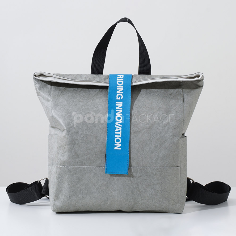 Gray Tyvek paper backpack with bold blue strap