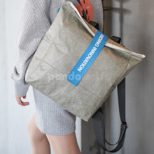 Gray Tyvek paper backpack with bold blue strap