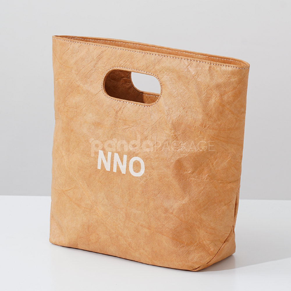 Reusable kraft-look non-woven tote bag with die-cut handles on display