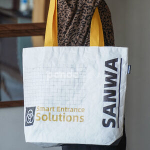White tear-resistant paper bag with yellow handles