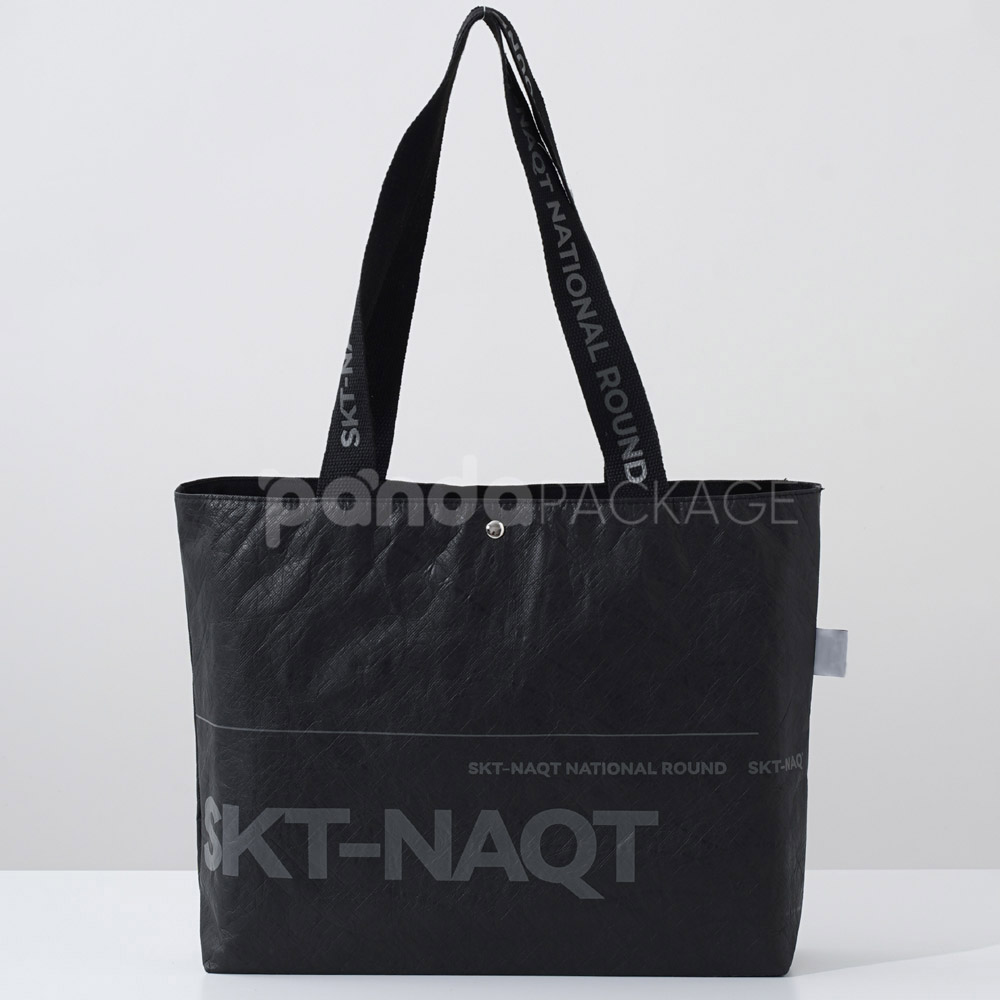 branded black paper bag with long webbing handles