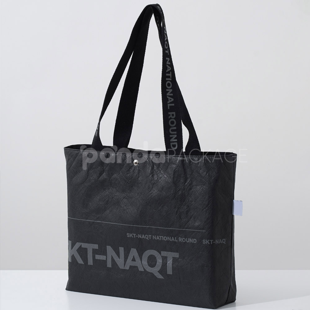branded black paper bag with long webbing handles