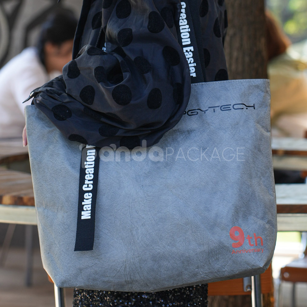 gray eco tote bag with brand logo and reinforced handles