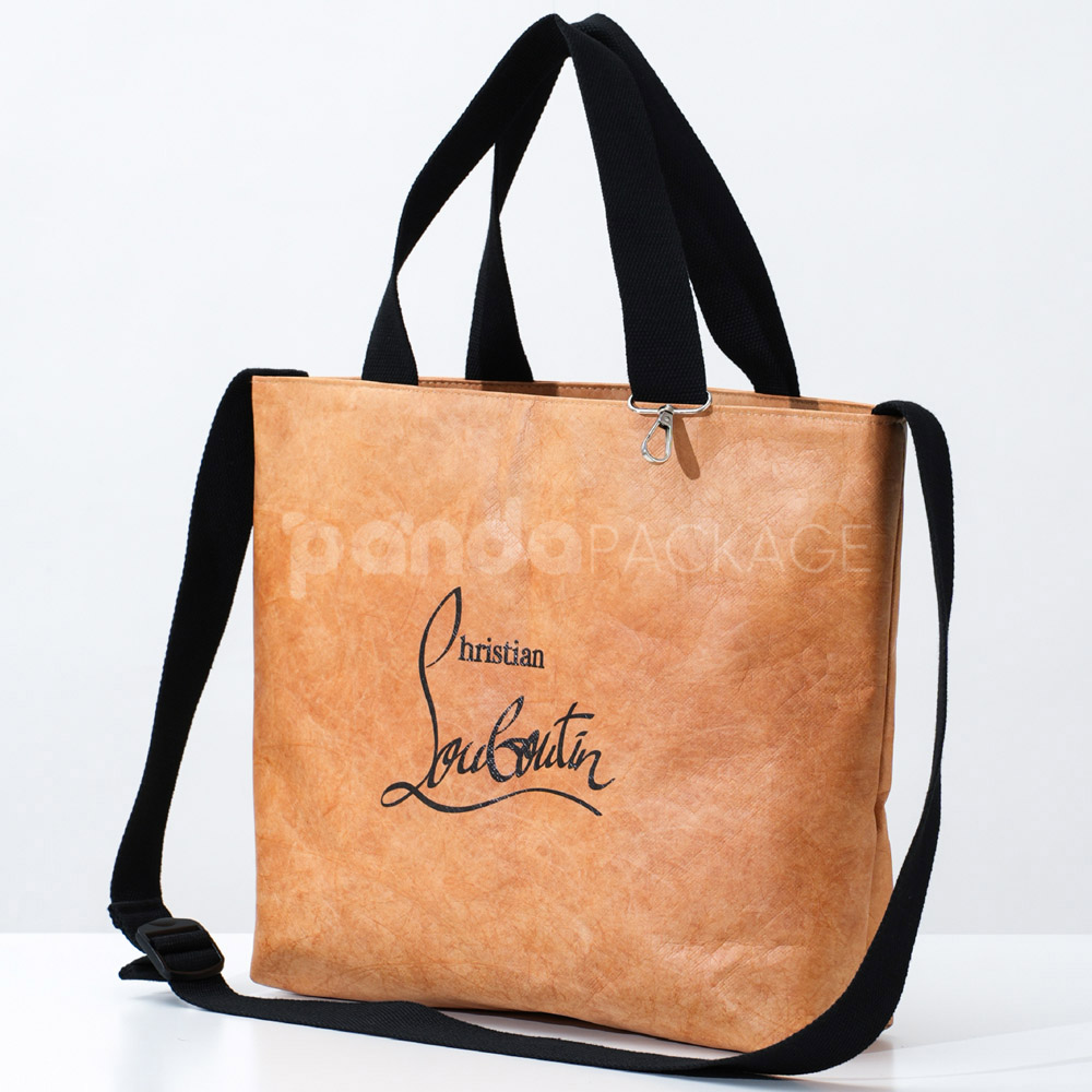 Brown kraft paper tote bag with black handles and shoulder strap