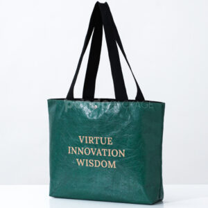 green paper tote bag with inspirational text and black handles