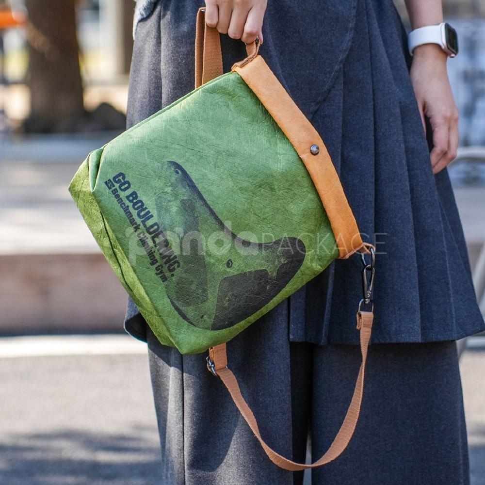 Eco-friendly green paper crossbody bag with brown strap