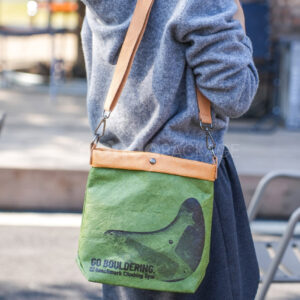 Eco-friendly green paper crossbody bag with brown strap