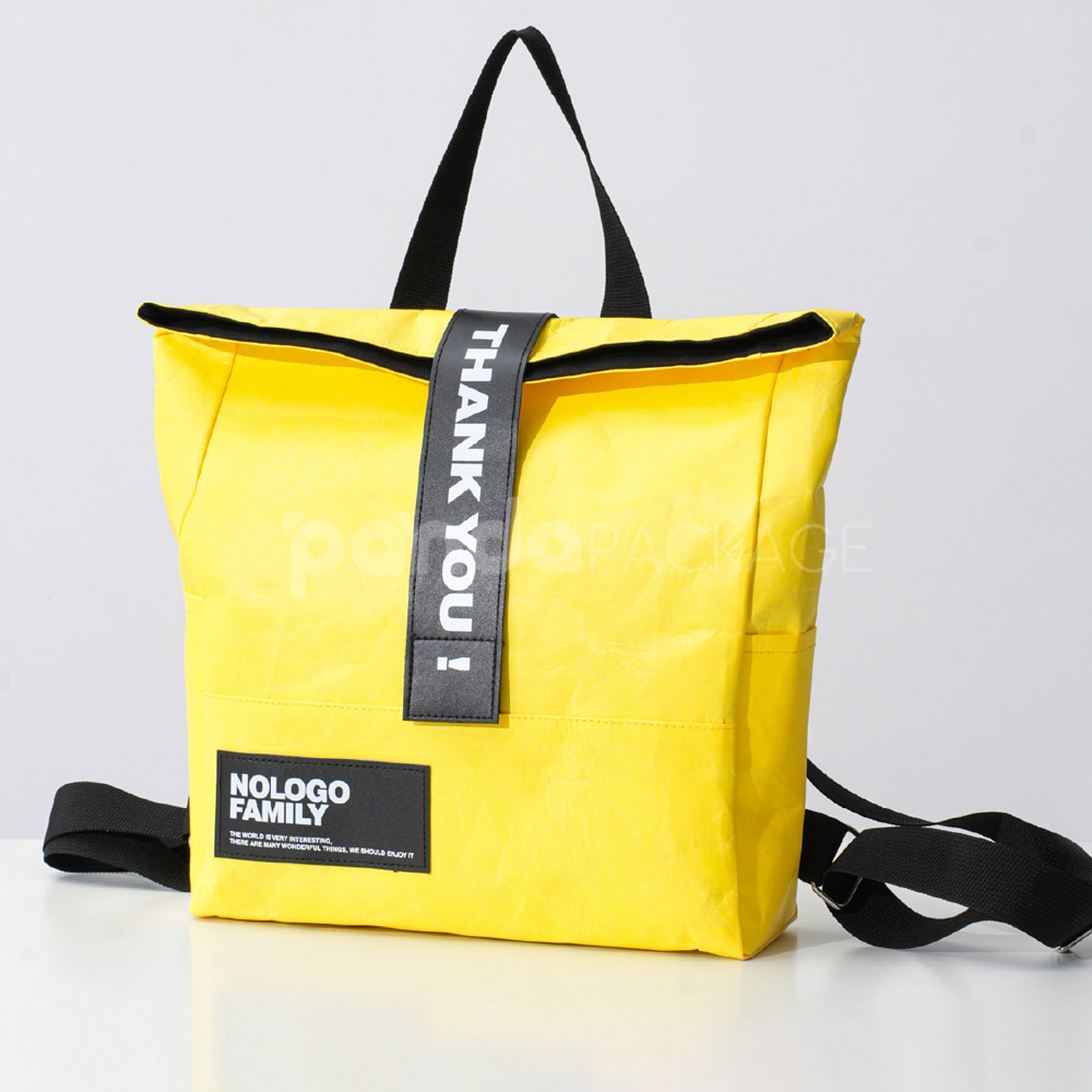yellow tyvek backpack with black strap and patch logo