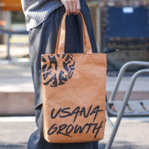 Eco-friendly kraft paper bag with flat handles and graphic design