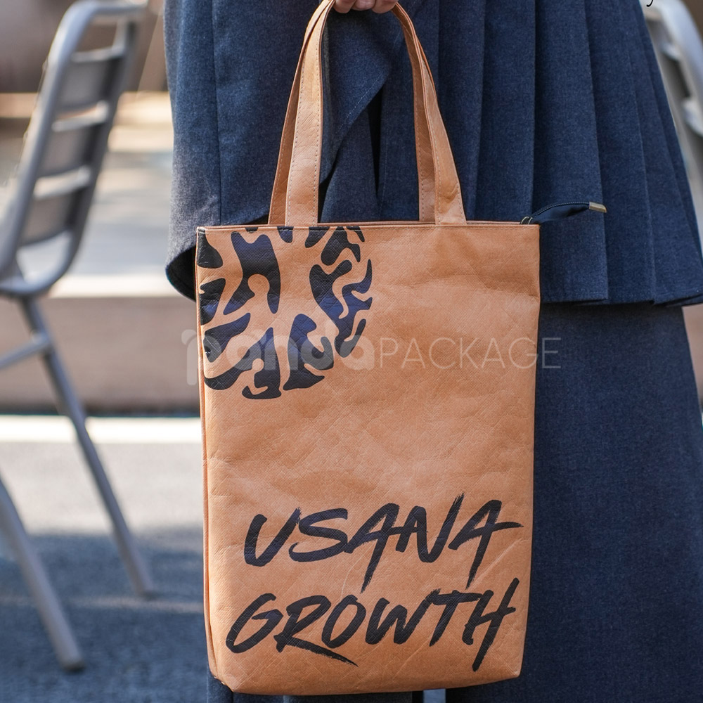 Eco-friendly kraft paper bag with flat handles and graphic design