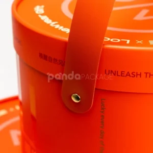 Custom orange round rigid box with lid and handle strap for luxury packaging
