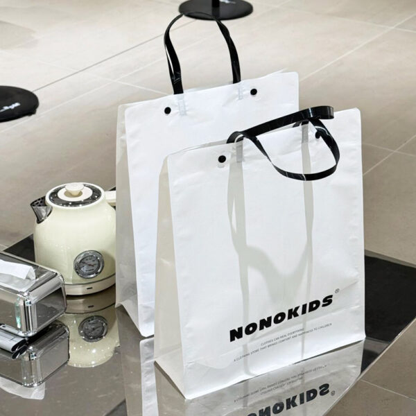 White Apparel Shopping Bag with Black Handles and Logo