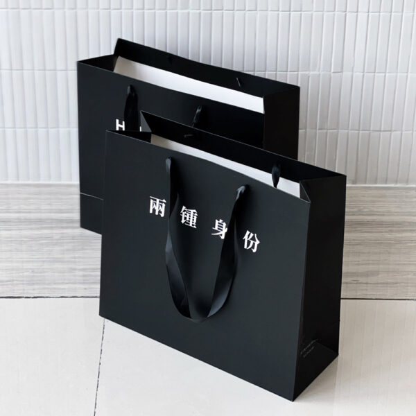 Black Apparel Shopping Bag with Elegant Minimalist Logo Design