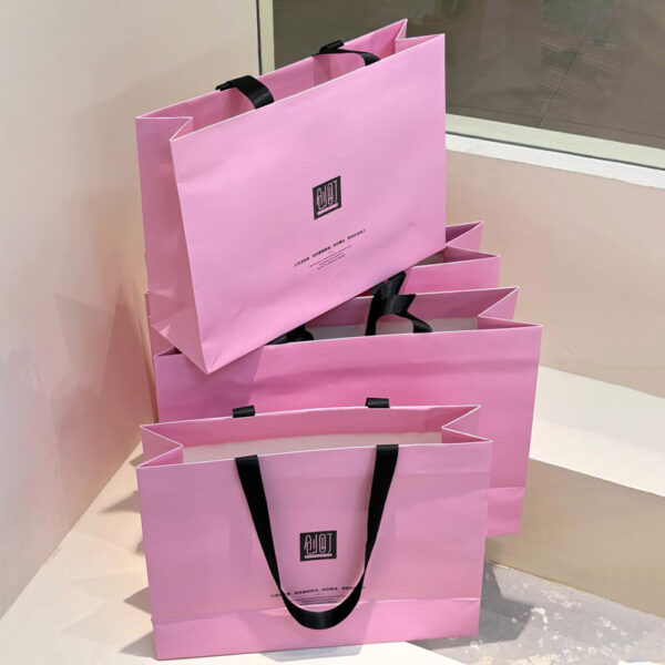 Pink Apparel Shopping Bag with Black Handles and Logo