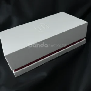 White lift-off rigid gift box with embossed logo and red accent