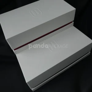 White lift-off rigid gift box with embossed logo and red accent