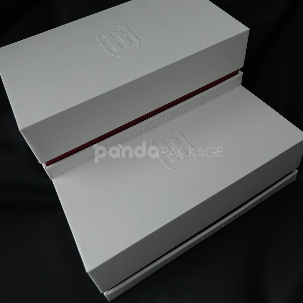White lift-off rigid gift box with embossed logo and red accent