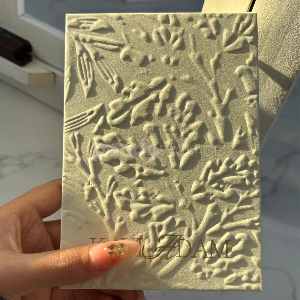 ivory embossed rigid paperboard box with gold foil logo