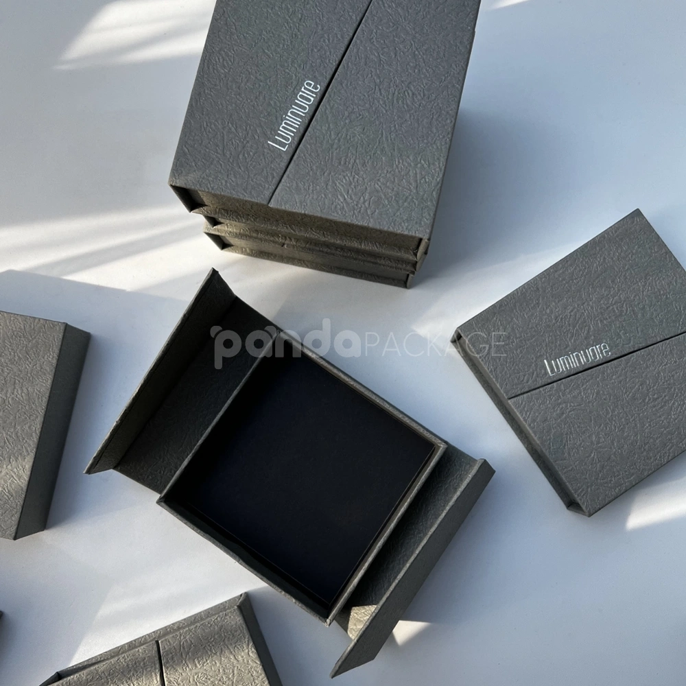 gray textured rigid flip lid box with silver foil stamping