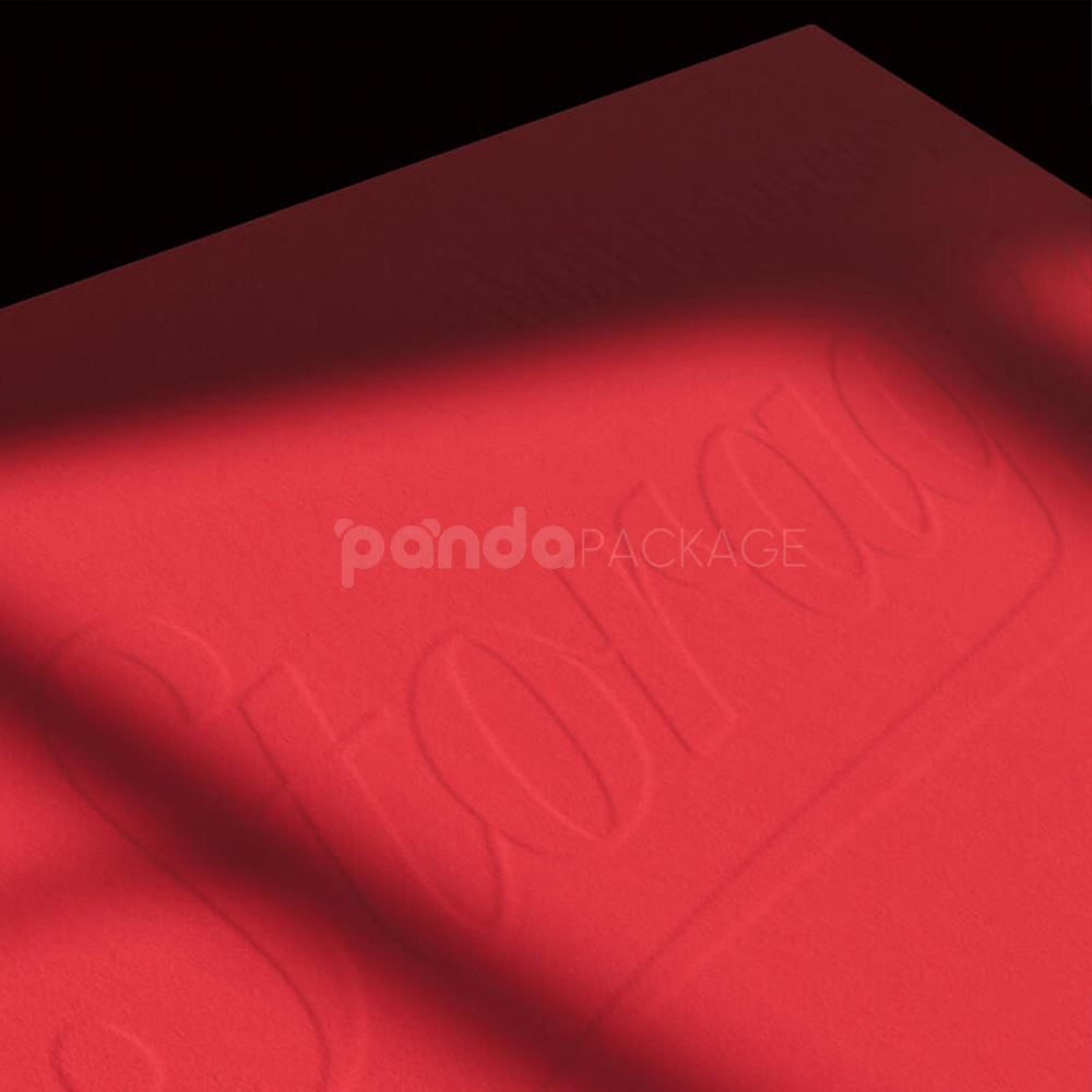 red triangle paperboard box with embossed logo and string tie closure