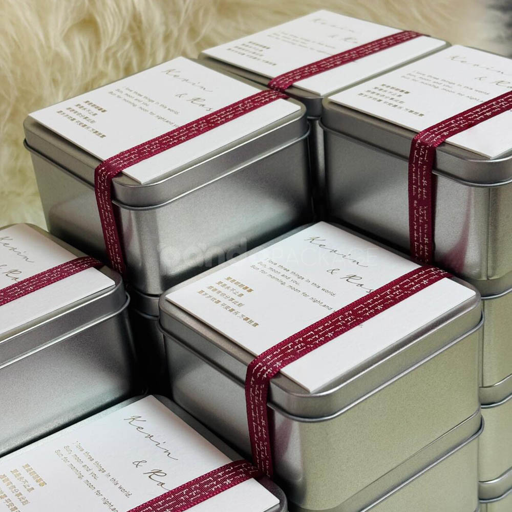 square silver tin box with decorative ribbon and customizable cover