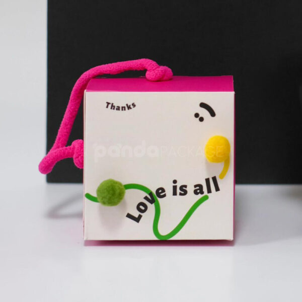 Playful Candy Gift Box with Colorful Pom-Poms and Pink Handle