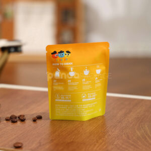 small gradient yellow–orange stand-up coffee pouch with matte surface
