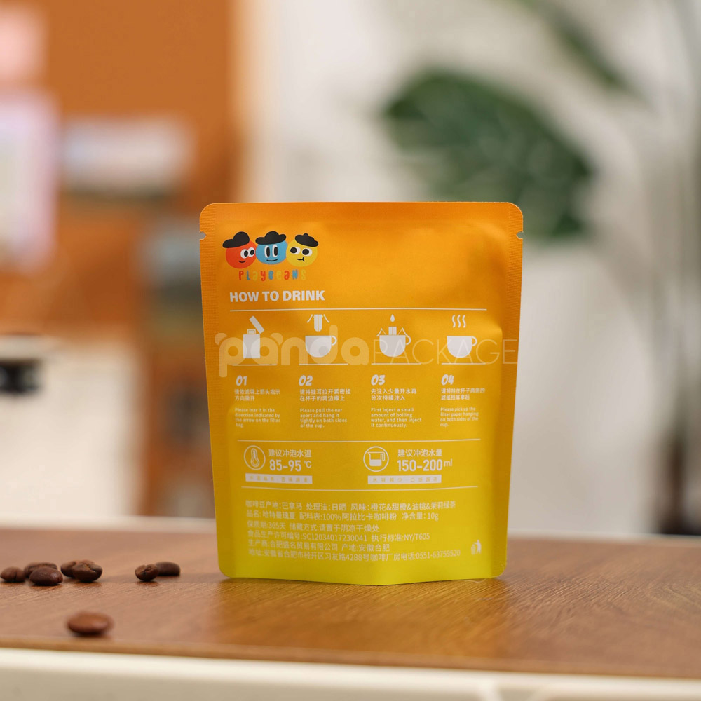 small gradient yellow–orange stand-up coffee pouch with matte surface