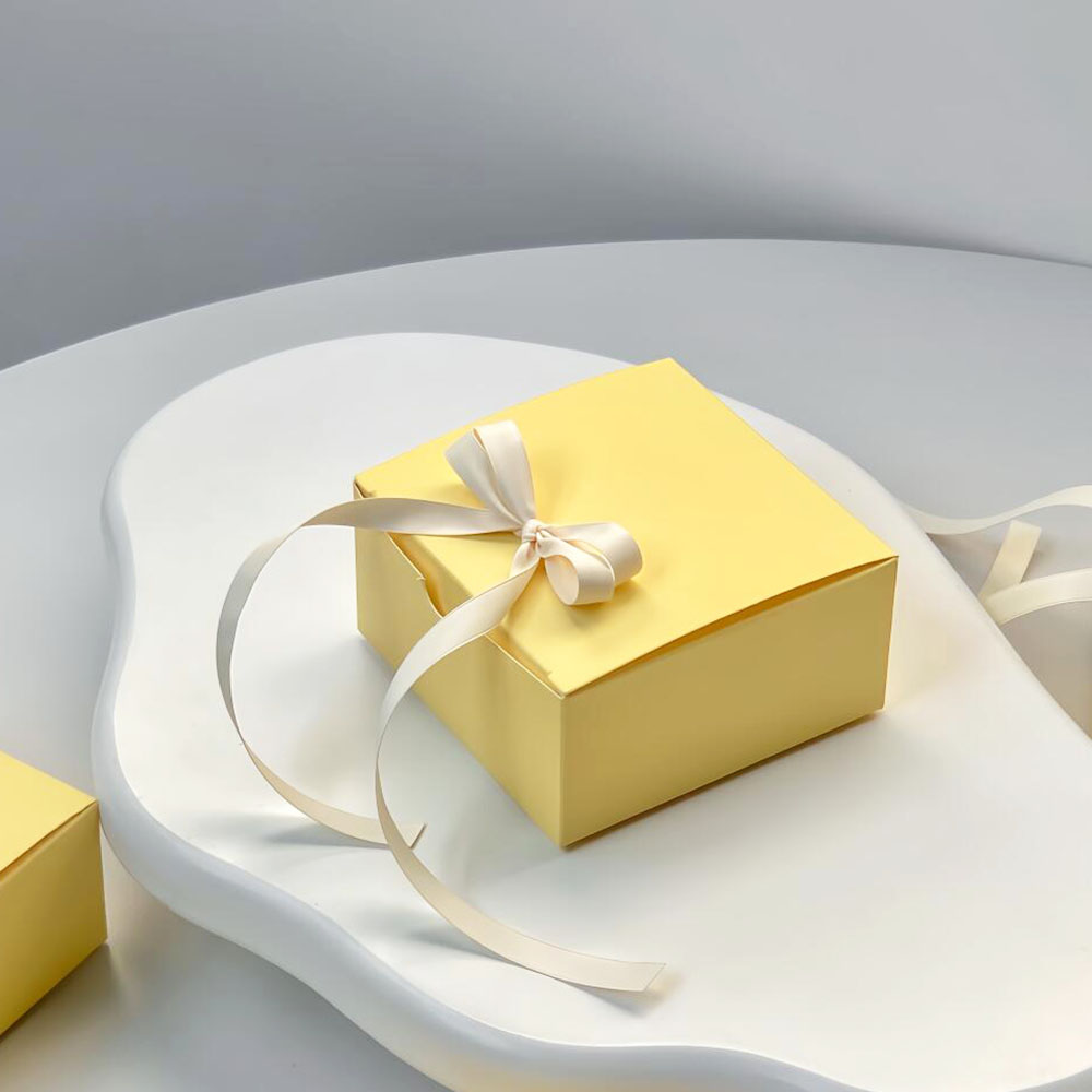 yellow paperboard gift box with satin ribbon for candy packaging