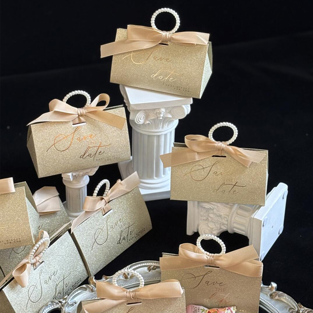 gold glitter candy favor box with pearl handle and ribbon