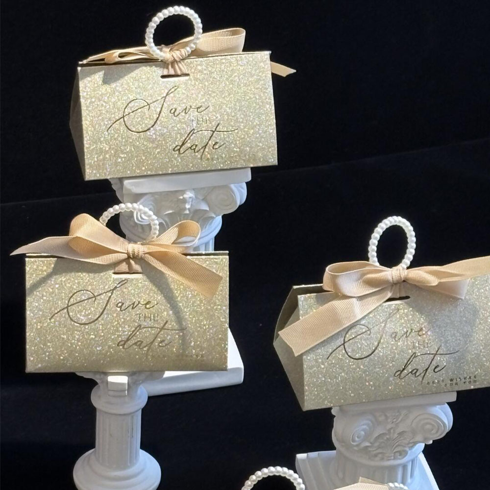 gold glitter candy favor box with pearl handle and ribbon